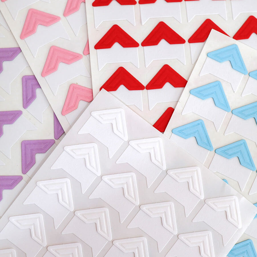 Stack of coloured photo corners