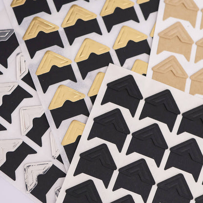 Stack of metallic and black photo corners